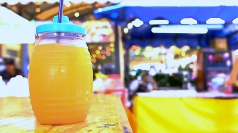 Man hands picks up fruit beverage outdoors 스톡 동영상 109083744