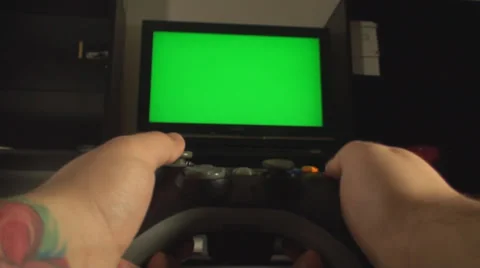 Man Hands Playing With A Console Controller And A TV With Green Screen Vídeos de archivo 35770054
