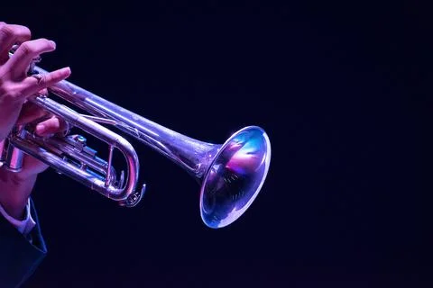 A man hands playing on a trumpet black background Stock Photos