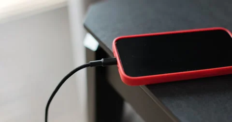 Man hands plugging a charger in a smartphone. Mobile smartphones charging. Stock Footage 278529422