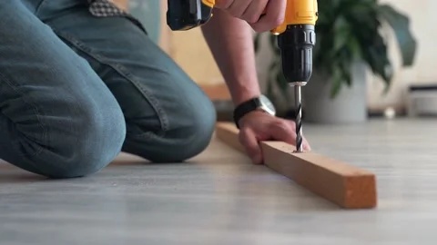 Man hands with power drill screwing wooden rail Stock Footage 167024094
