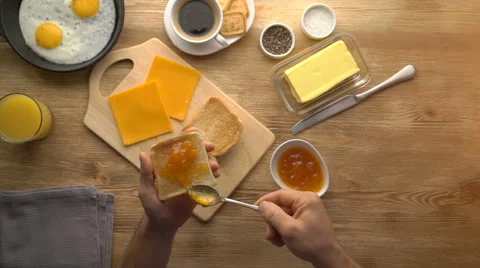 Man hands preparing breakfast toast with jam, top view Stock Footage 67535097