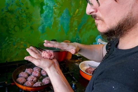 Man hands preparing meatballs with raw mincemeat. Lifestyle close up composit Stock Photos