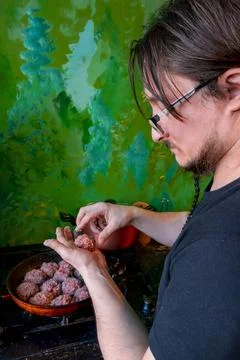 Man hands preparing meatballs with raw mincemeat. Lifestyle close up composition Stock Photos