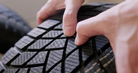 Man hands probe tire to check work surface for reliability Vidéo 294603076