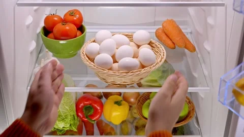 Man hands put a basket organic chicken eggs in the fridge Stock Footage 260770118