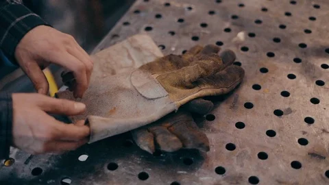 Man hands put on gloves slow motion shallow depth of field Видео 104078773