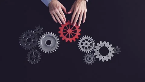 Man hands putting a cogwheel into a common mechanism. Stock Footage 260233274