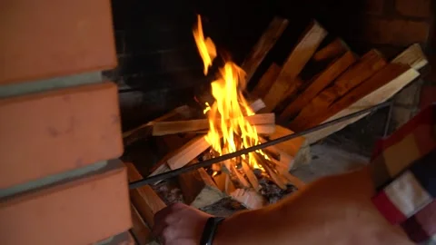 A man hands putting the logs on the fire. Firewoods. Hand close up. Stock Footage 196717208