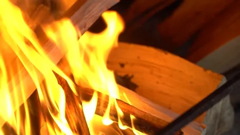A man hands putting the logs on the fire. Firewoods. Hand close up. Stock Footage 196717708