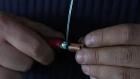 Man hands putting terminal lug onto stripped copper power cable. Video stock 344365629