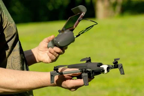 Man hands with remote control and drone Foto stock