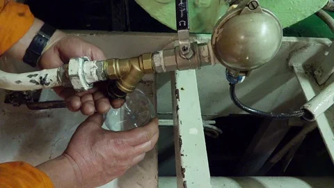 Man hands remove pipe cork and drain oil into plastic bottle 動画素材 121119841