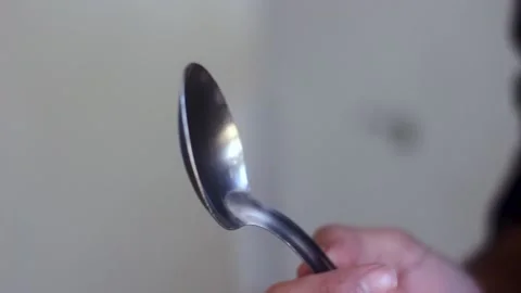 Man Hands Rotating and Checking a Spoon Stock Footage 148409779