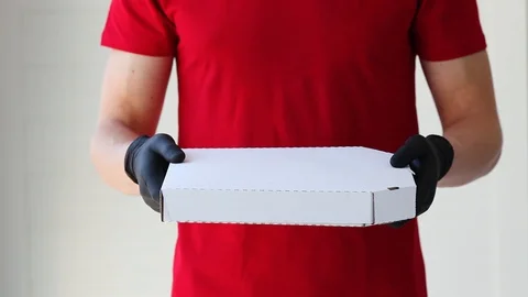 A man hands rubber gloves with a box pizza. Stock Footage 128986212