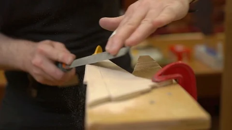 Man hands saw old passenger jetliner model wing on support Stock Footage 127112688