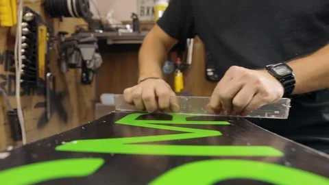 Man Hands With Scraper Scrape The Wax Off The Snowboard. Follow Shot Stock Footage 125855734