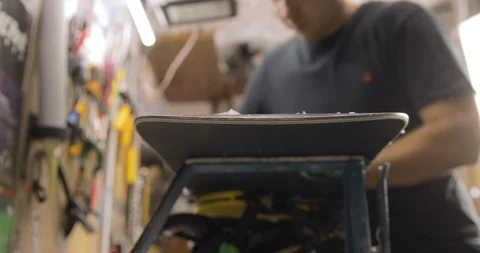 Man Hands With Scraper Scrape The Wax Off The Snowboard. Front View Stock Footage 125856027