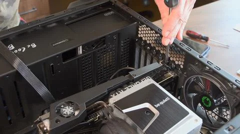 Man hands with screwdriver assemble CPU cooler with NVidia GeForce graphics card Stock Photos