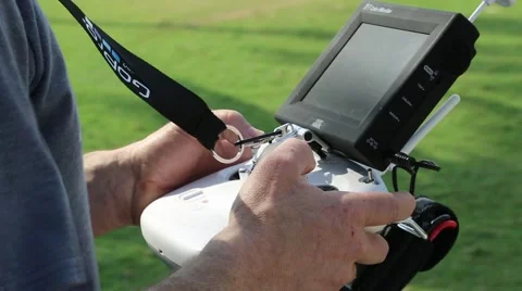 Man hands seen in flying a drone by remote control Stock Footage 48547770