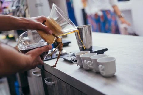 Man hands serving coffee while standing in coffee shop Stock Photos