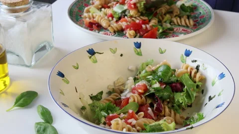 Man hands serving a pasta salad on a plate. Stock Footage 195951202