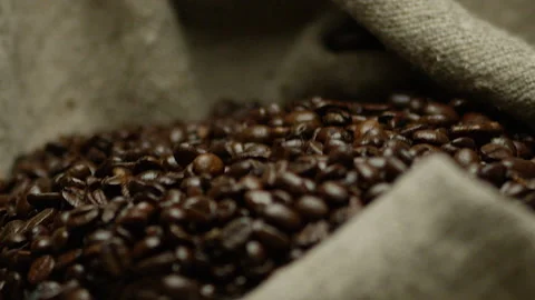 Man hands shaking the burlap bag with coffee beans Stock Footage 142071649