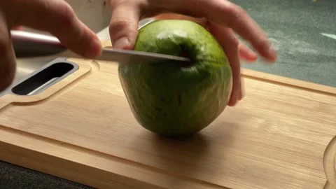 Man hands with sharp knife cut large avocado wooden board. his hands close up Stock Footage 233370682