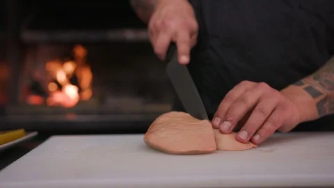Man hands сhef cutting foie gras with a knife raw lunch condiment preparation Stock Footage 103288600