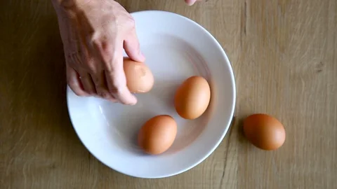 Man Hands is Shelling Chicken Eggs. Stock Footage 129176229