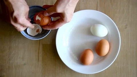 Man Hands is Shelling Chicken Eggs. Stock Footage 129176235