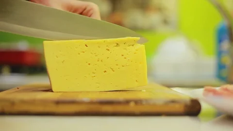 Man hands slices cheese with knife on wooden board Stock Footage 95930185