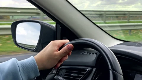 Man hands on steering wheel close up driving car Stock Footage 220255242