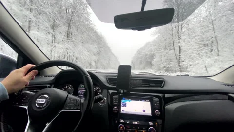 Man hands on steering wheel driving car by winter highway Stock-Footage 226974578