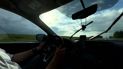 Man hands on steering wheel driving car at sunny day Stock Footage 255835775