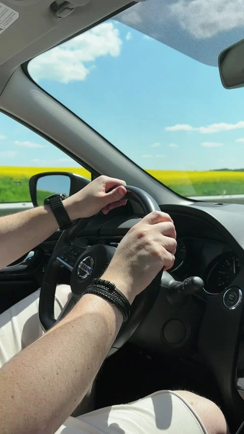 Man hands on steering wheel riding by highway at sunny day Stock Footage 247689306