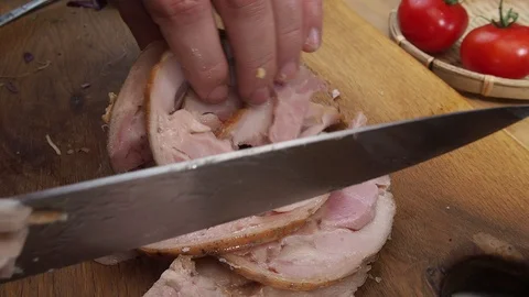 Man hands, take the sliced chicken meatloaf, and transfer it to the side Stock Footage 129807596