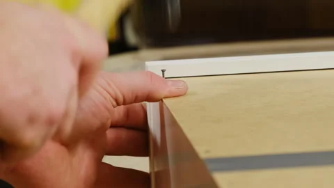 Man hands tap on small nail to fix wall using hammer at workshop Video stock 304397520