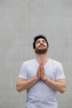 Man with hands together, looking up Stock Photos