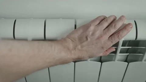 The man hands tries to keep warm on the battery. Energy crisis Stock Footage 222786477