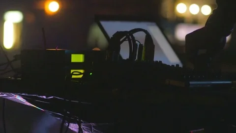 Man hands turning knobs on professional DJ mixer console at party, 4k Stock Footage 77625307