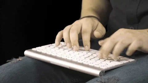 Man hands typing on a computer keyboard. Black background Stock Footage 76393910