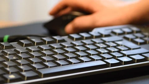 Man hands typing on a computer keyboard and using a wireless mouse Stock Footage 101948653