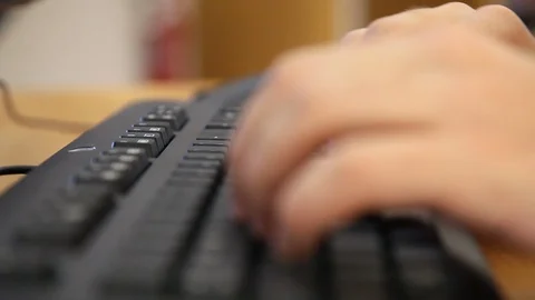 Man Hands Typing On A Keyboard in a Library_CloseUp Stock Footage 85881183