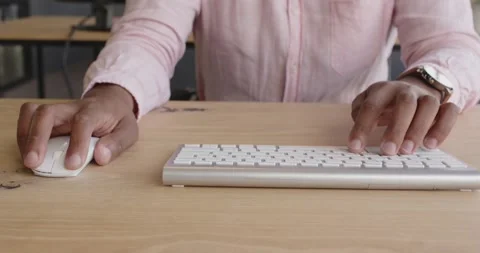 Man hands typing on keyboard at office desk, focusing on work Stock Footage 346285313