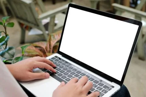 Man hands typing laptop computer with blank screen for mock up template backg Stock Photos