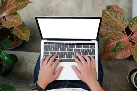 Man hands typing laptop computer with blank screen for mock up template backg Stock Photos