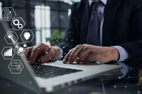 Man hands typing on laptop computer keyboard and surfing the internet on office Fotos Stock