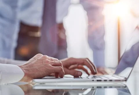 Man hands typing on laptop computer keyboard, close up. Stock Photos