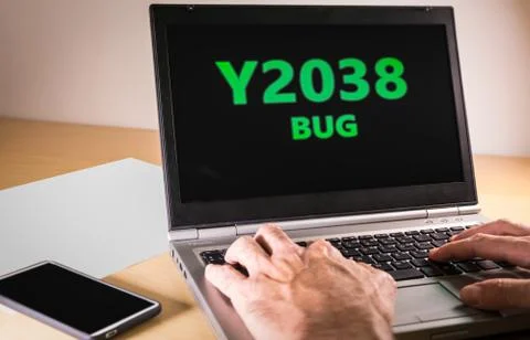 Man hands typing on a laptop in text code. Y2038 problem concept Foto stock